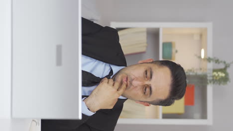 Vertical-video-of-Home-office-worker-man-depressed-and-unhappy.